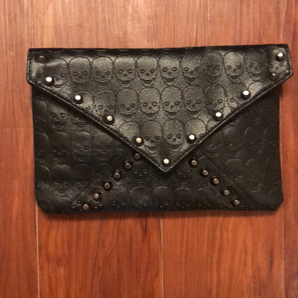Never used black clutch with skulls and spikes